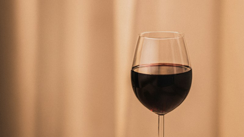 Glass of red wine representing alcohol interaction with Armodafinil