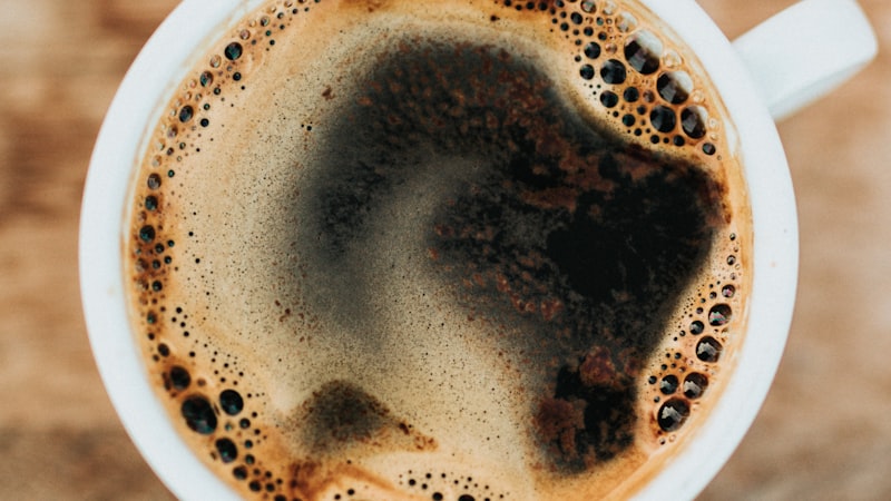 White ceramic mug of coffee representing caffeine and Armodafinil interaction