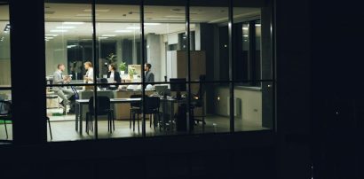 Team working late at night in an office representing shift work and Armodafinil use