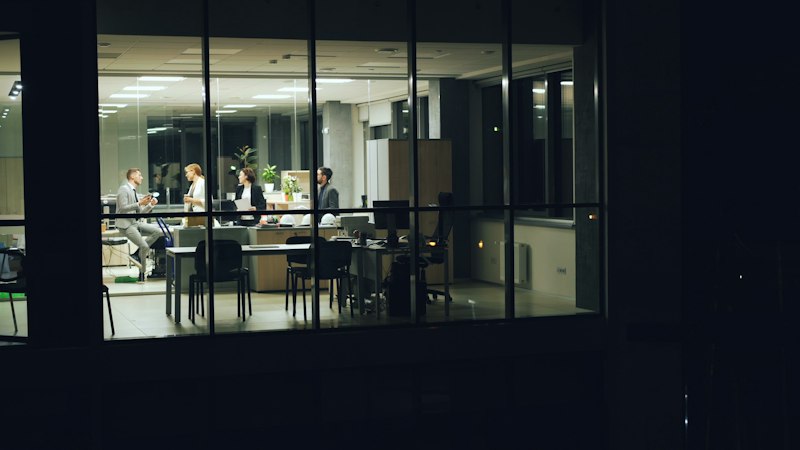 Team working late at night in an office representing shift work and Armodafinil use