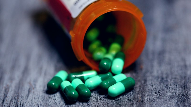 Prescription bottle with capsules representing long-term Armodafinil tolerance