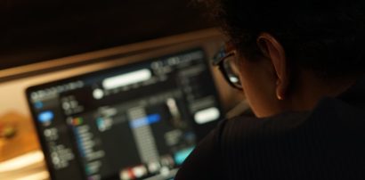 Person focused at a computer screen representing concentration and alertness
