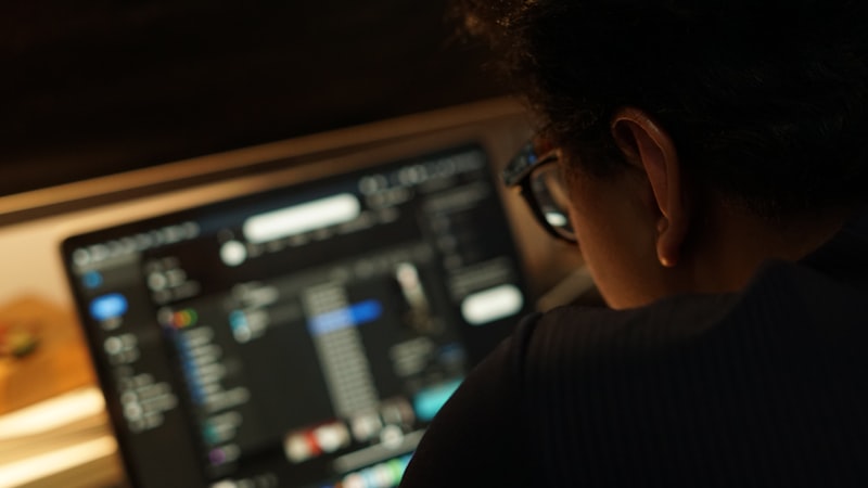 Person focused at a computer screen representing concentration and alertness