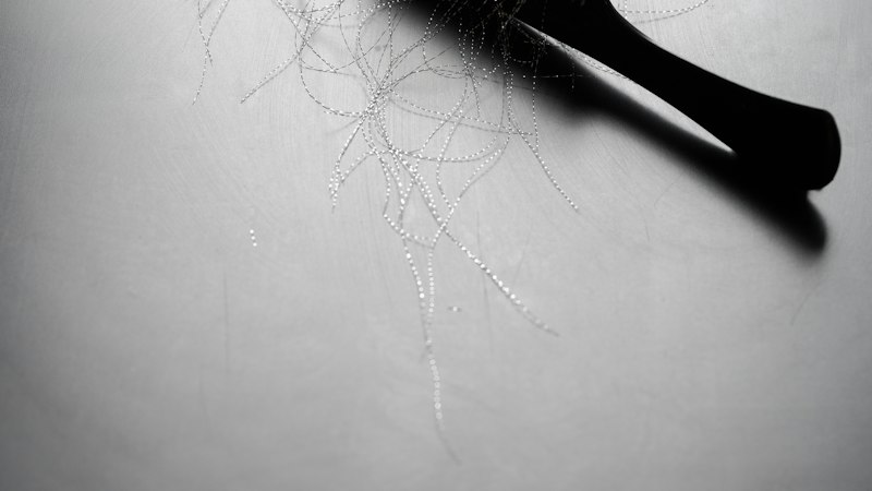 Comb with strands of hair representing male pattern hair loss treatment with Finasteride