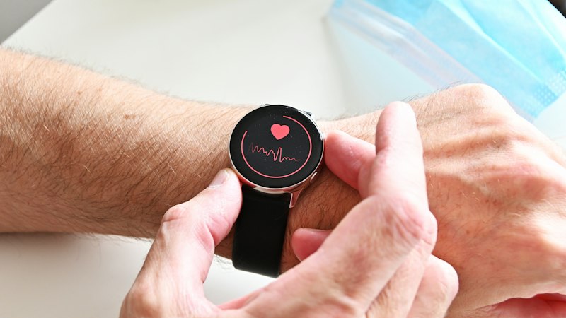 Person checking heart rate monitor on a smartwatch representing Ivabradine for heart rate control